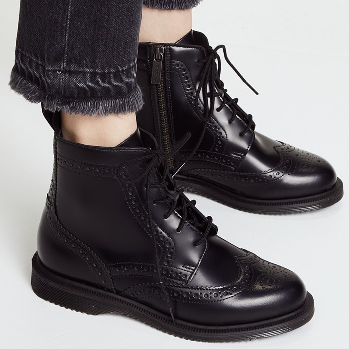 Dr. Martens ‘Delphine’ boots showcase timeless brogue detailing with a modern twist, featuring polished leather, lace-up design, and classic Airway soles