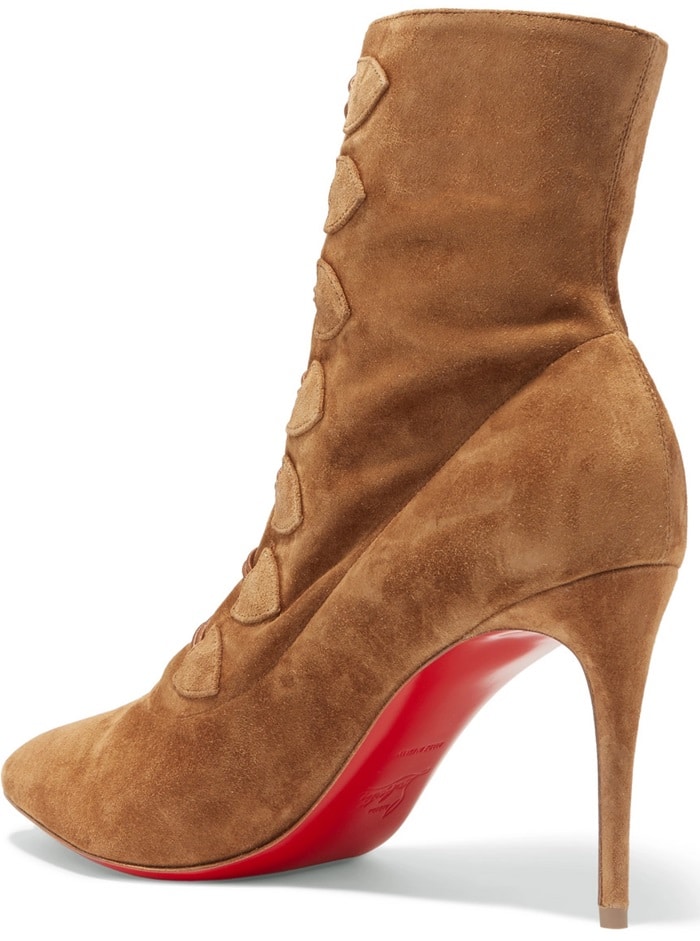 Tan Christian Louboutin “French Tutu” suede ankle boots featuring vintage-inspired button detailing, sharply pointed toes, slender stiletto heels, and the designer’s signature red lacquered soles