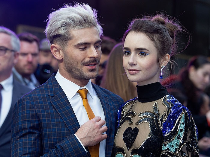 Lily Collins radiates elegance in her heart-hand Elie Saab gown while Zac Efron admires the details at the Extremely Wicked, Shockingly Evil and Vile London premiere