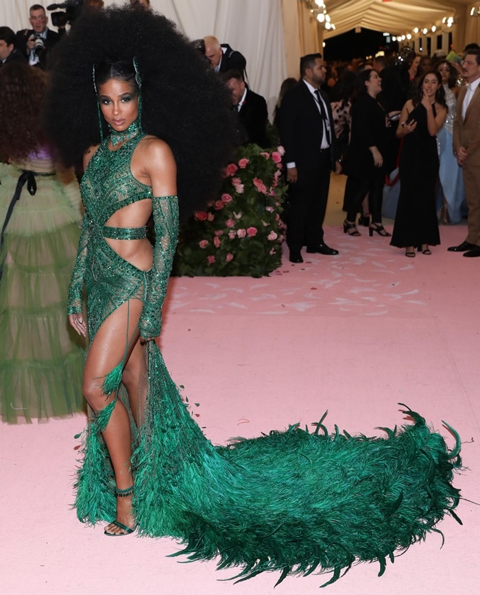 Ciara embraced Studio 54 glamour at the 2019 Met Gala in a feather-trimmed emerald Peter Dundas gown paired with custom Gianvito Rossi sandals and a dramatic Diana Ross-inspired Afro