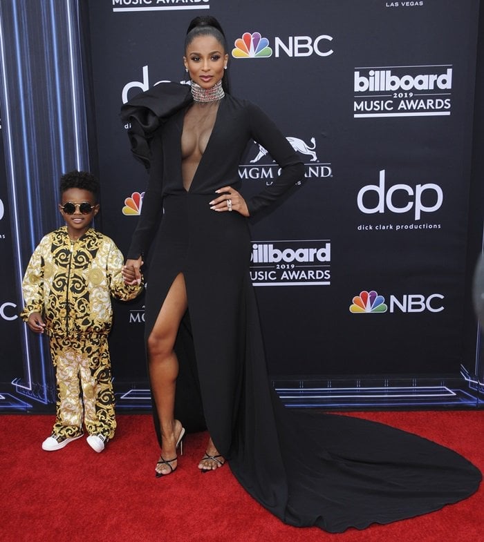 Joined by son Future Jr., Ciara lets the gown’s thigh-high slit frame her minimalist black footwear on the Billboard Music Awards red carpet