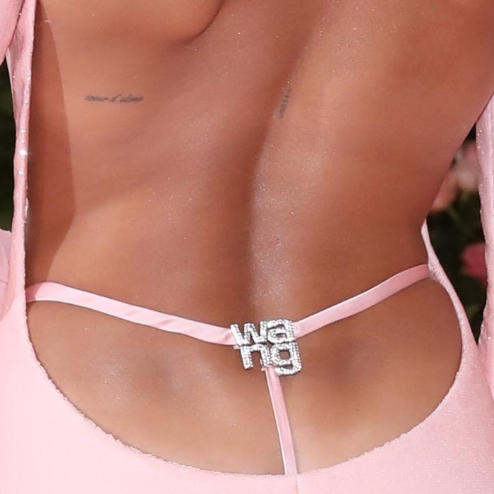 A close-up of the crystal-embellished “WANG” nameplate thong revealed the intentionally provocative styling detail that anchored Hailey Bieber’s exaggerated “Barbie-chic” Met Gala look