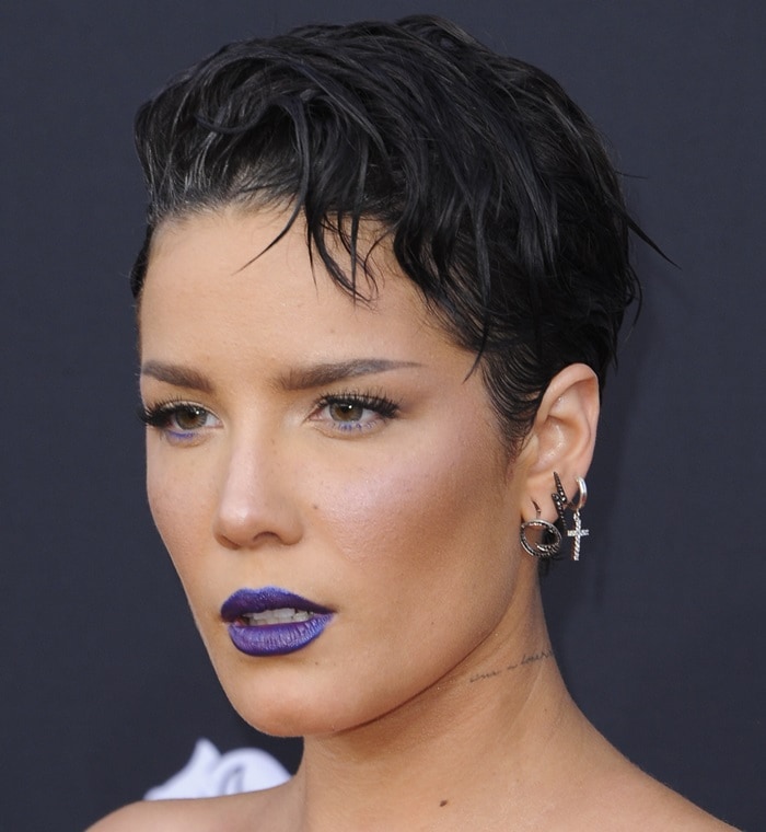 Close-up beauty shot of Halsey showcasing vivid cobalt-blue lipstick, subtle blue eyeliner accents, and layered Hearts On Fire and A Little Too Much earrings at the 2019 Billboard Music Awards