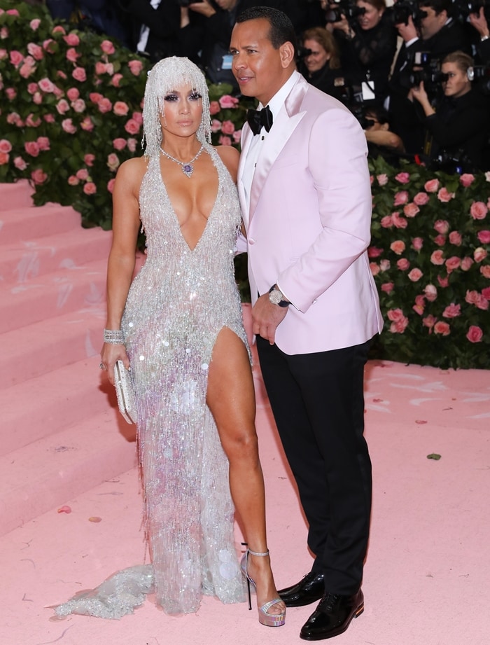 Jennifer Lopez arrived at the 2019 Met Gala at the Metropolitan Museum of Art on May 6, 2019, alongside then-fiancé Alex Rodriguez, commanding the pink carpet in sky-high silver ankle-strap stilettos that amplified the drama of her crystal-fringed Versace gown