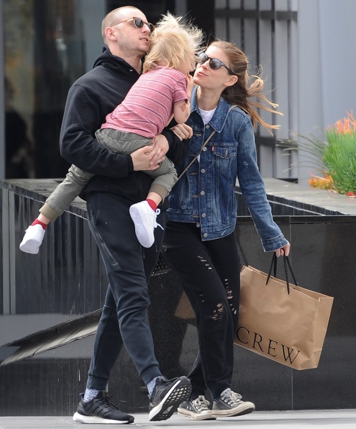 Kate Mara shares a sweet moment with her stepson while out shopping with Jamie Bell at The Americana in Glendale on April 8, 2018, keeping it off-duty in a denim jacket, distressed black jeans, and worn-in Converse sneakers that add a relaxed, lived-in finish to the family outing