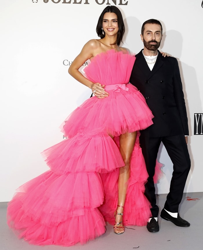 Kendall Jenner poses with Giambattista Valli in the bubblegum-pink tulle gown that previewed their HM collaboration at the 2019 amfAR Cannes Gala