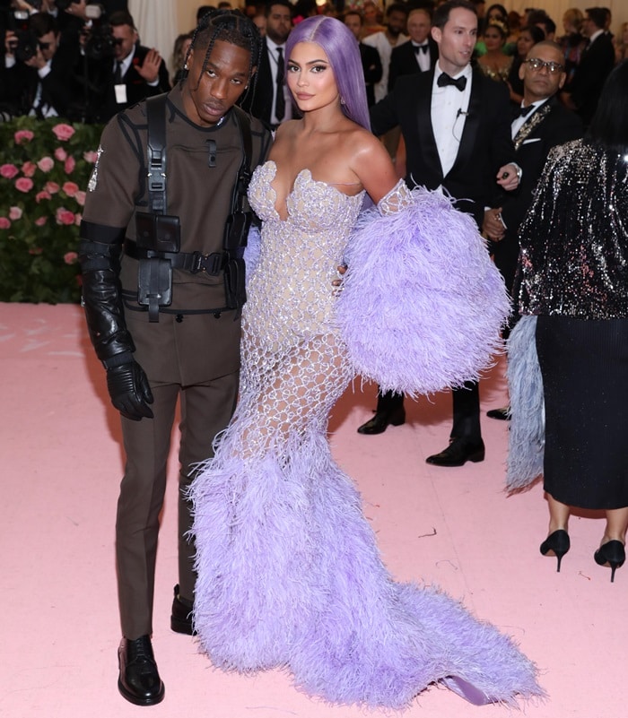 Kylie Jenner stunned in a feather-trimmed, lavender Versace gown and matching wig as she joined her rapper boyfriend Travis Scott—who wore a military-inspired look—at the 2019 Met Gala at the Metropolitan Museum of Art in New York City on May 6, 2019