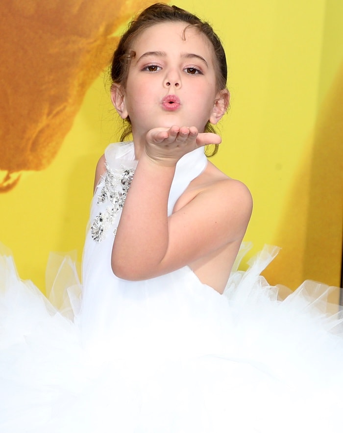 Lexi Rabe blows a kiss in a princess-style white tulle gown embellished with sparkling details by Isabella Couture