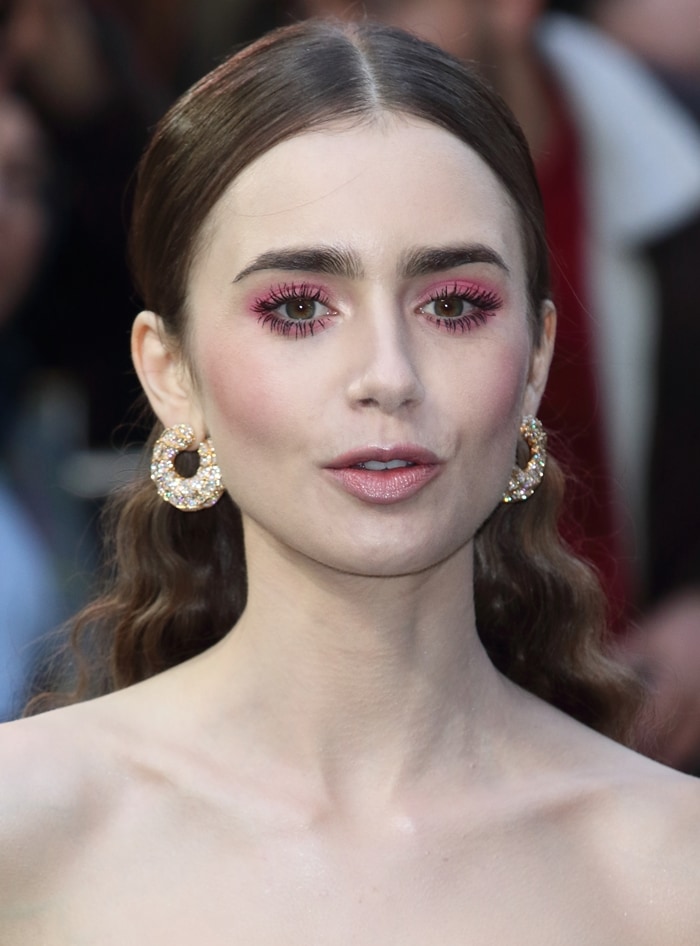 Lily Collins' hot pink eye makeup and gold hoop earrings