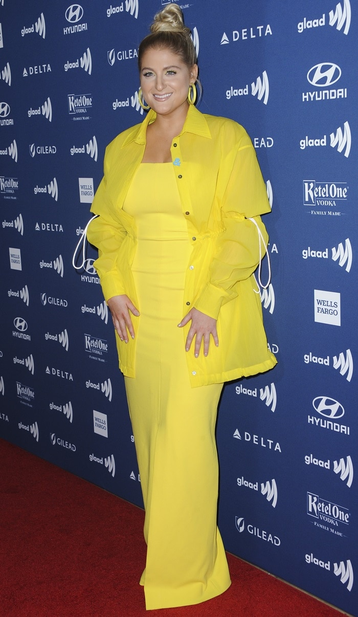Meghan Trainor embraces tonal dressing in a bright yellow Solace London gown and matching drawstring overshirt at the 2019 GLAAD Media Awards