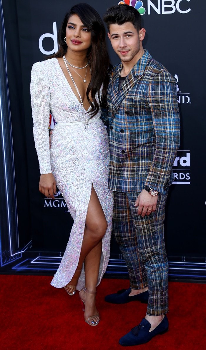 Priyanka and Nick Jonas pose together on the red carpet, her clear PVC sandals contrasting his patterned Missoni suit