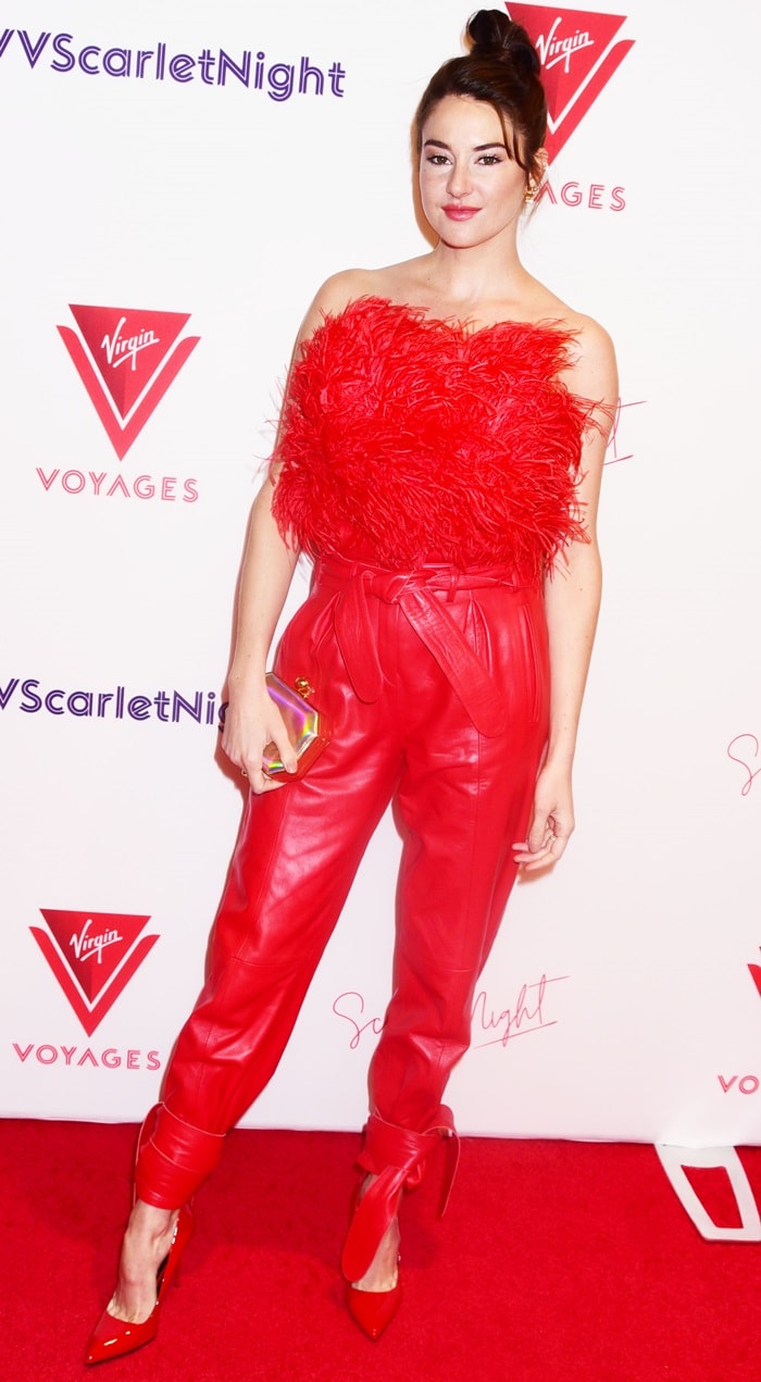 Shailene Woodley wears a red feathered Attico top, red leather pants, and matching pointed-toe pumps at the Virgin Voyages Scarlet Night Party