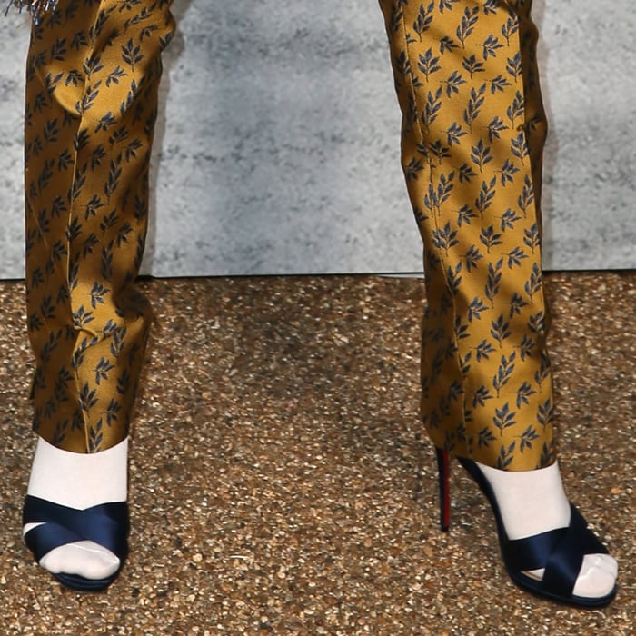 FKA Twigs wears white socks with navy satin crisscross high-heeled sandals