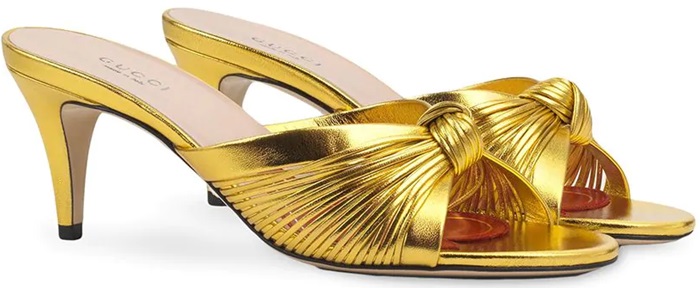 Rendered in high-shine gold leather, Gucci’s knot-detail mules combine a softly gathered upper with a refined mid-height heel for balanced evening wear