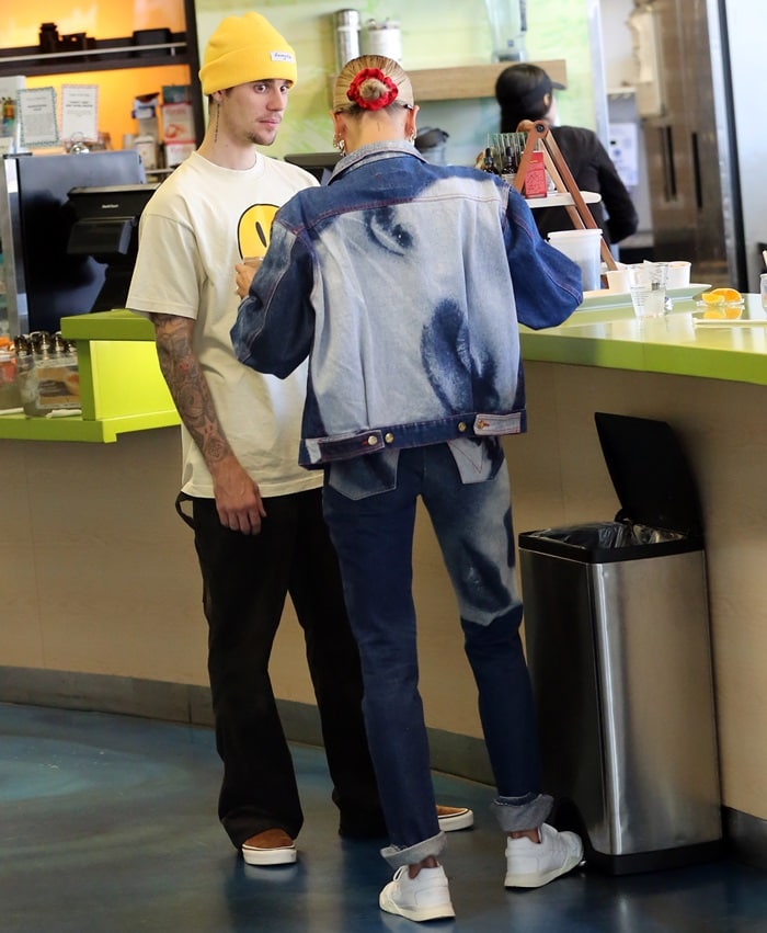 Justin Bieber and Hailey Bieber keep their off-duty style effortlessly coordinated at Earthbar in West Hollywood on May 30, 2019, with Hailey pairing a bleached denim jacket and cuffed jeans with clean white low-top sneakers that sharpen the relaxed silhouette with a crisp, minimalist finish