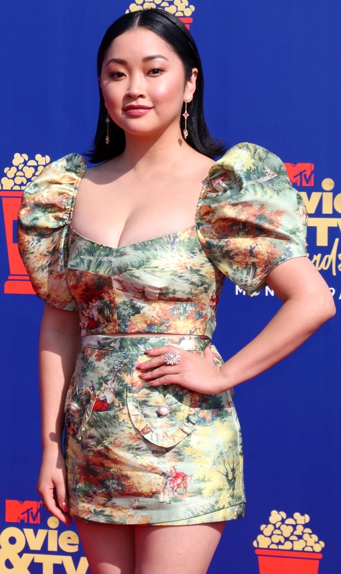 Lana Condor looks radiant in a printed Alice McCall mini dress featuring puffed sleeves and heart-shaped pockets