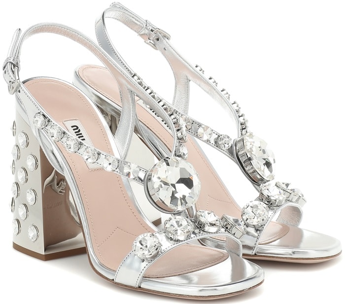 Miu Miu crystal embellished silver sandals shown from an angled view