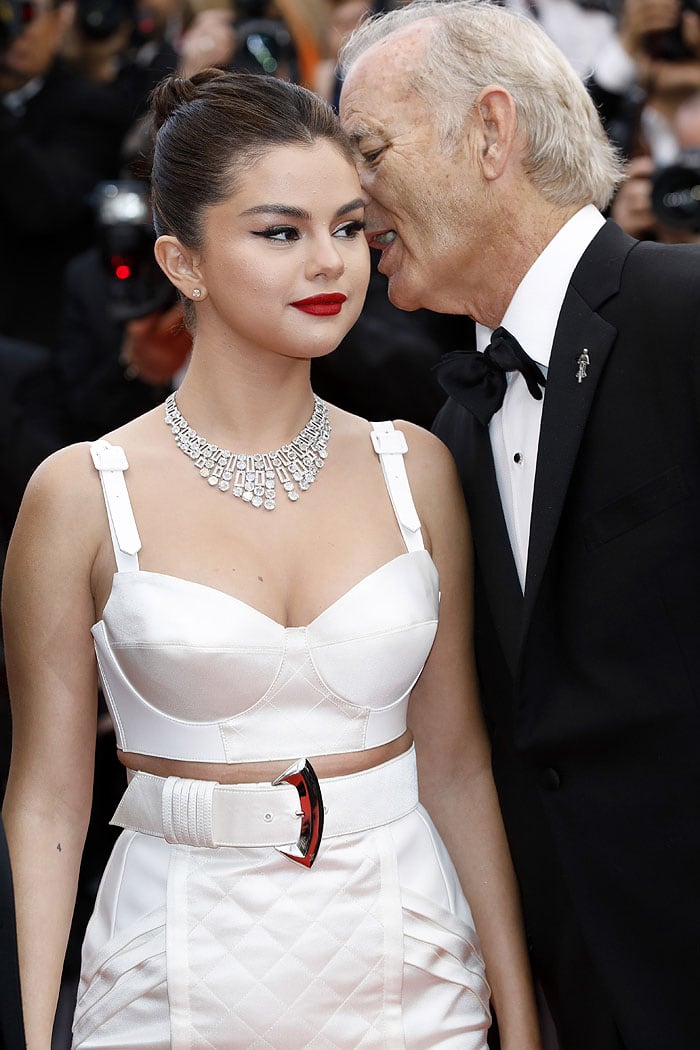 Bill Murray whispering something in Selena Gomez's ear on the 2019 Cannes Film Festival red carpet