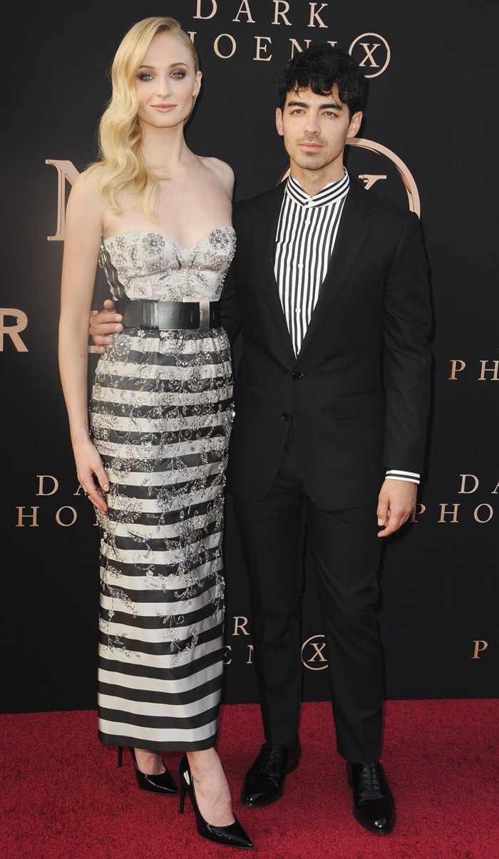 Sophie Turner towers over Joe Jonas in a stunning strapless silver gown paired with sky-high black pointed-toe pumps
