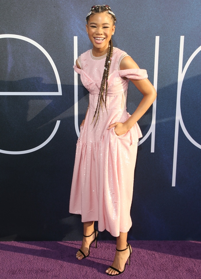 Storm Reid lit up the purple carpet in a feminine pink sequined dress by Irish designer Simone Rocha, styled with strappy black Jimmy Choo sandals for a chic contrast