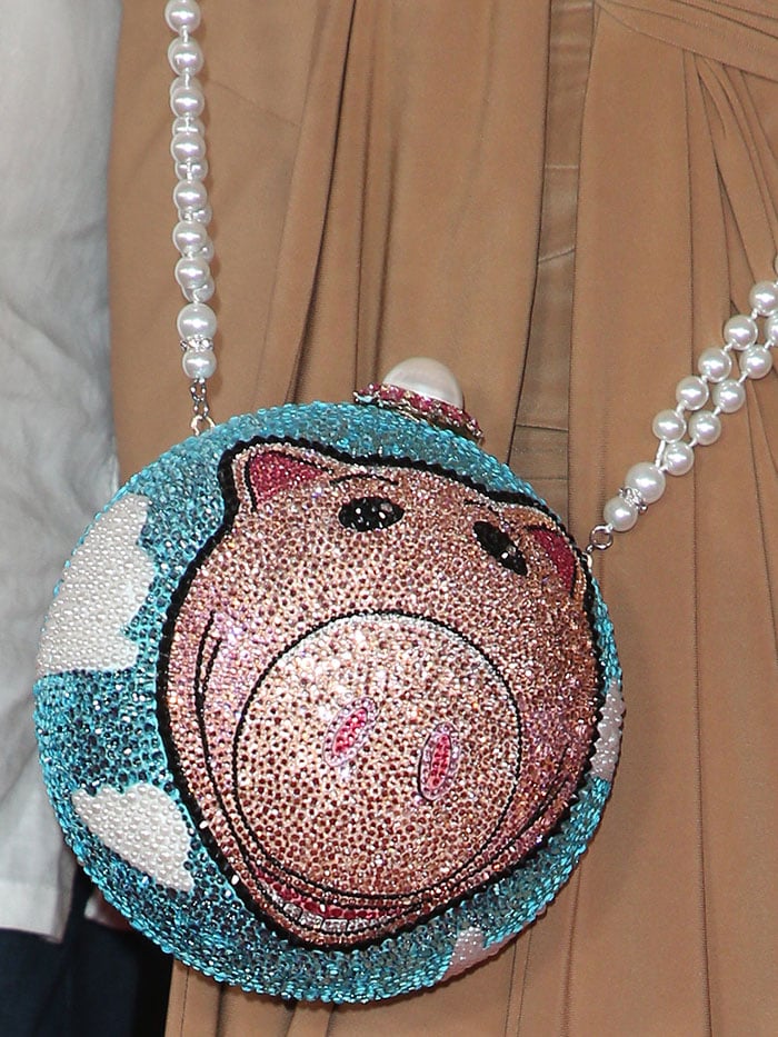 Details of the rhinestone-studded circle purse bearing the image of Hamm, which is the piggy bank Toy Story character voiced by John Ratzenberger