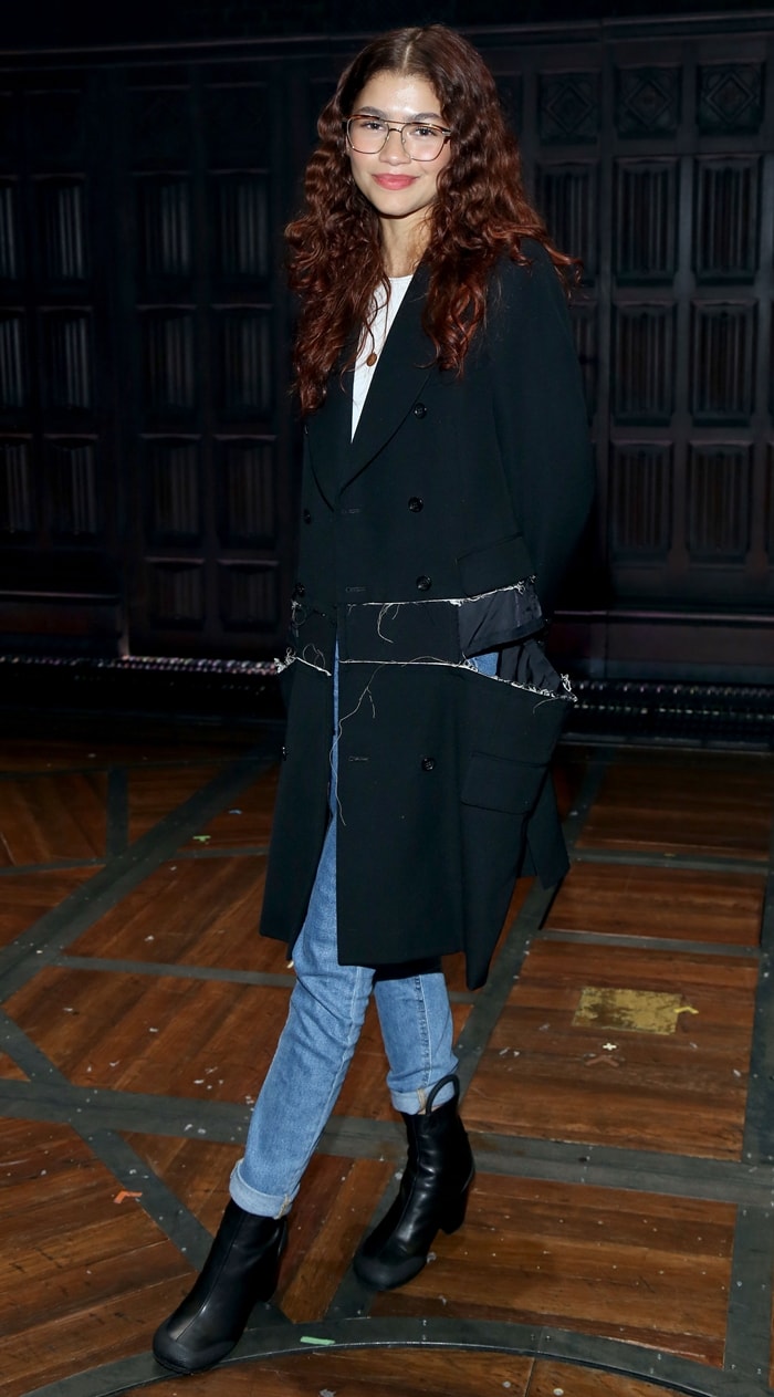 Zendaya keeps it casual-chic in cuffed jeans, chunky black platform boots, and a statement trench coat while attending Harry Potter and the Cursed Child at the Lyric Theatre in NYC