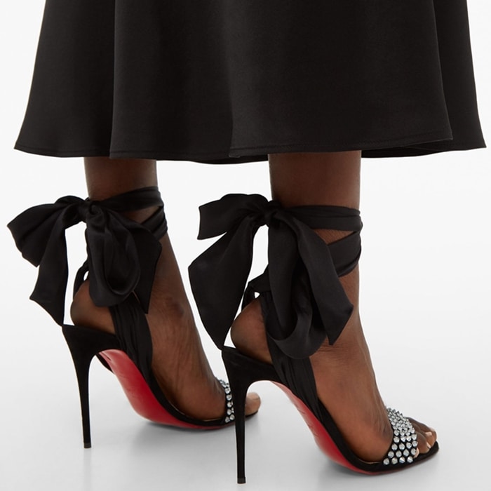 These sandals are crafted in Italy from supple suede with the label's long-reigning spikes in iridescent grey crystals across the front strap, then set on a towering stiletto heel