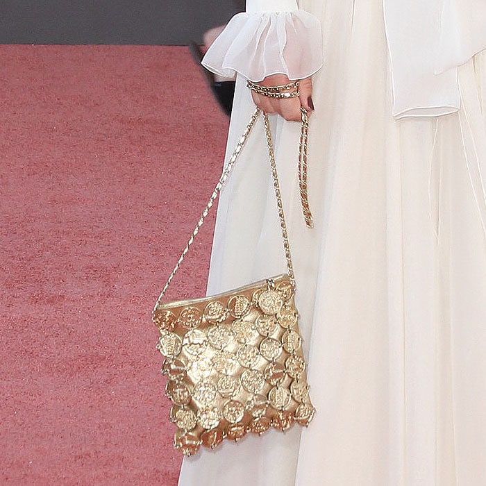 Margot Robbie carrying a gold Chanel Cruise 2018 coin-embellished chain bag