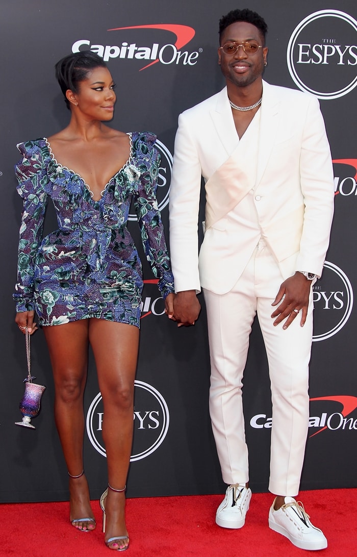 Gabrielle Union and Dwyane Wade coordinate statement-making red carpet style at the 2019 ESPYs, with Union in Raisa Vanessa and Wade in a crisp white suit and sneakers