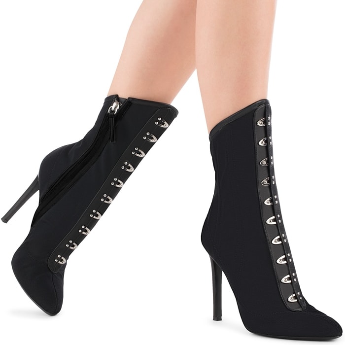 Giuseppe Zanotti's Janice booties reinterpret Victorian footwear through sheer mesh construction, polished hardware detailing, and sleek stiletto heels