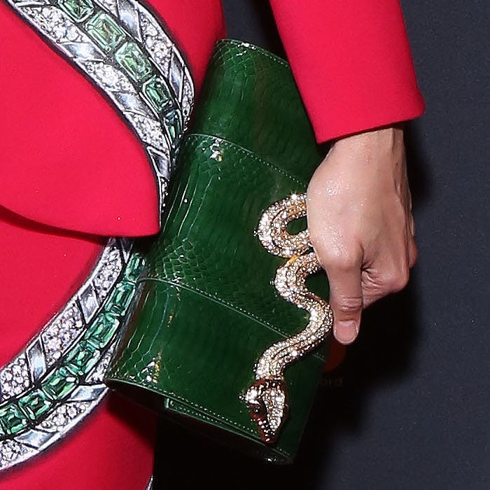 Details of Karen Olivo's Judith Leiber Couture "Serpent" bag, crafted in emerald snakeskin and finished with a crystal-encrusted snake clasp that echoed the hand-painted motif on her custom Carolina Herrera suit