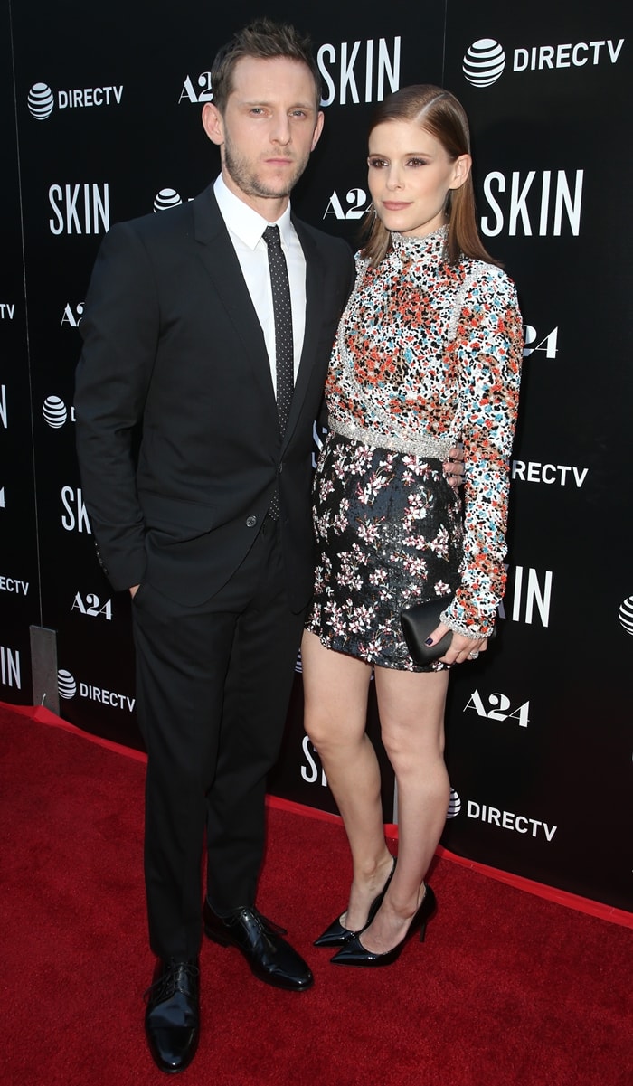 Kate Mara with her husband, Jamie Bell, at the Skin premiere at the ArcLight Hollywood on July 12, 2019, pairing a Giambattista Valli Spring 2019 Haute Couture floral mini dress with sleek black pointy-toe pumps that ground the look with classic red-carpet polish