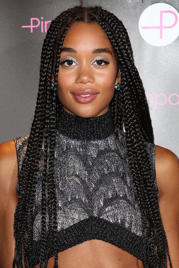 A shimmery Louis Vuitton knit crop top with an angular hem framed Laura Harrier’s look, balanced by silver-toned makeup and emerald Bulgari earrings