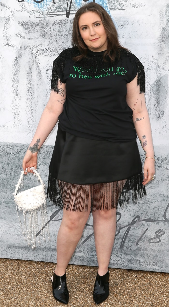 At the Serpentine Gallery Summer Party, Dunham paired Christopher Kane's slogan T-shirt with a fringe-trimmed skirt and the designer's sleek patent-leather slingbacks.