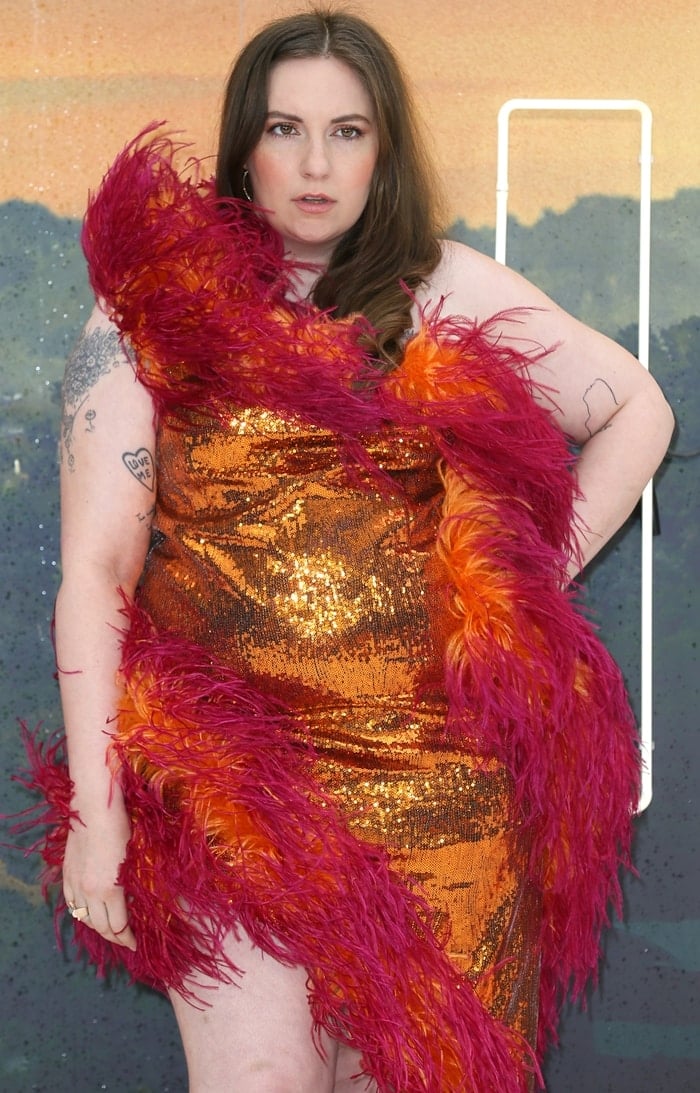 Orange sequins and fuchsia feather trims transformed Dunham's one-shoulder gown into one of the most visually striking looks at the London premiere
