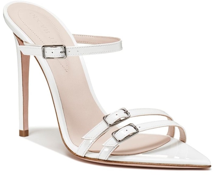 The Oscar Tiye Dea mule combines a pointed toe, triple buckle straps, and an elegant stiletto heel in smooth white leather