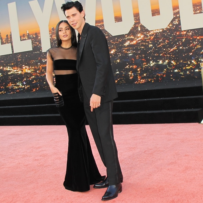 Vanessa Hudgens and Austin Butler coordinate in sleek black, with her sheer-panel Armani gown contrasted by his slim tuxedo and patent Chelsea boots that nod to retro Hollywood polish