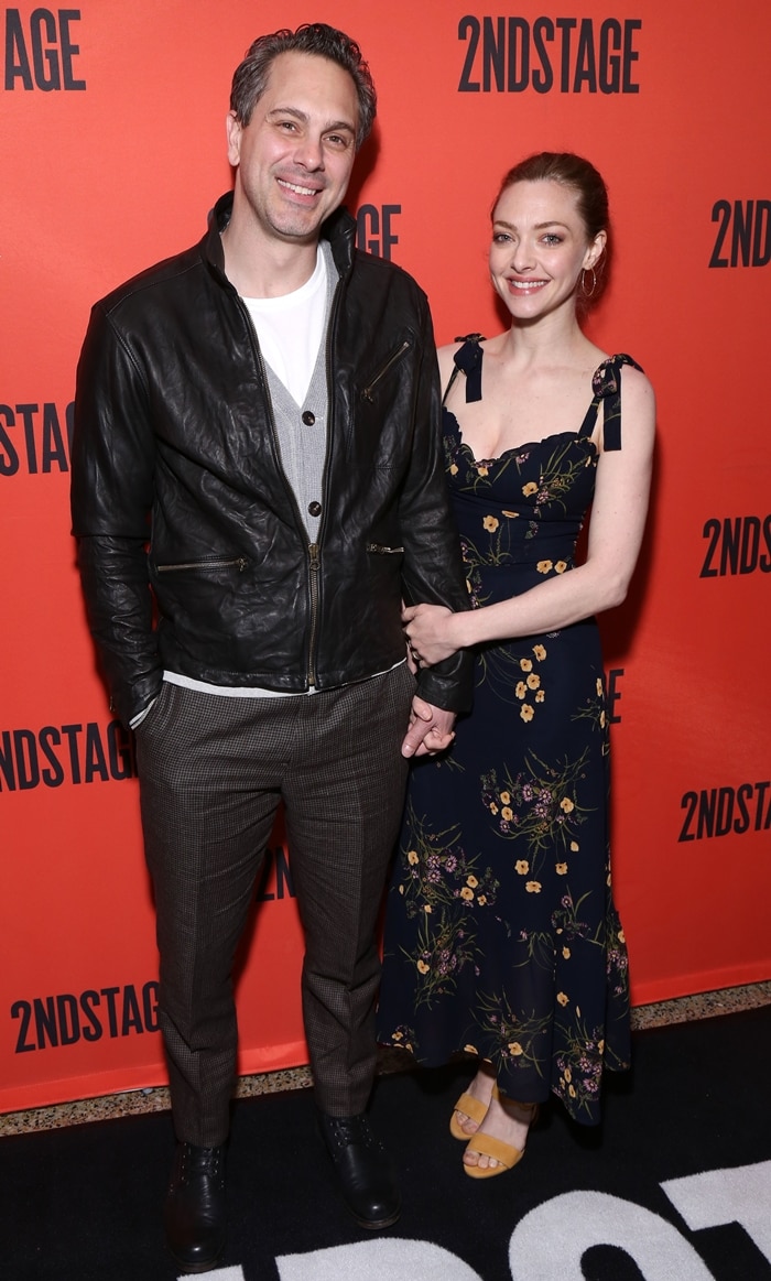 Amanda Seyfried looks lovely in a floral midi dress paired with yellow platform sandals while posing with her husband, Thomas Sadoski, at the Second Stage Theater event