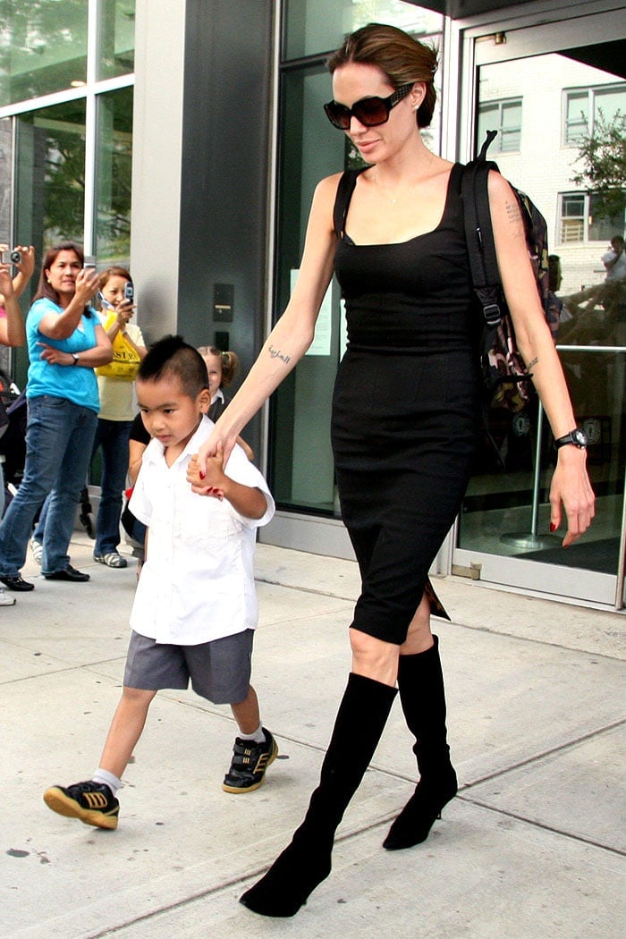 Angelina Jolie turns a school pickup into a runway moment in a sleek black dress and knee-high suede boots while picking up Maddox from NYC’s Lycée Français on October 5, 2007