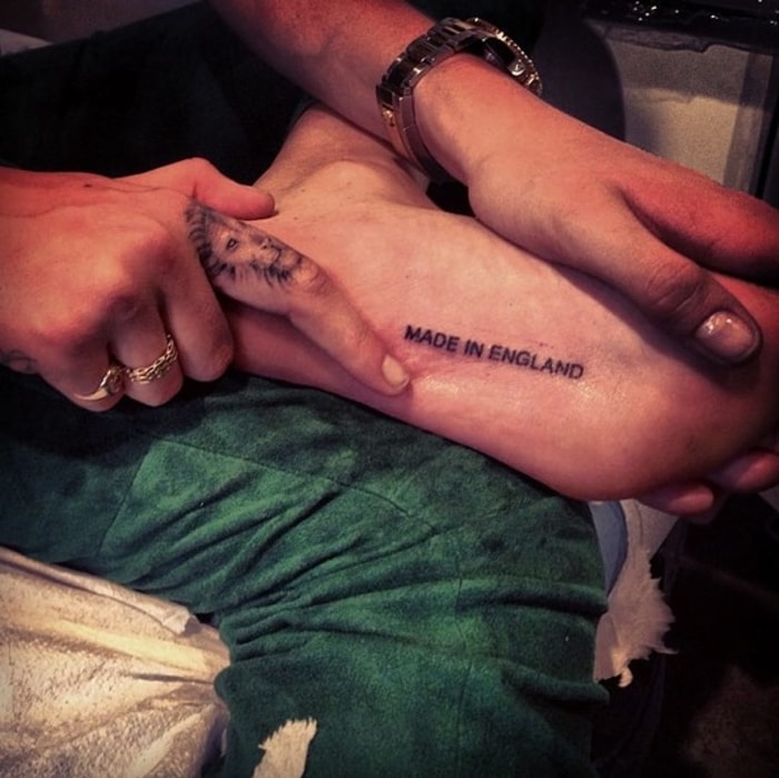 Cara Delevingne has a tattoo that says ‘Made In England’ on the sole of her foot