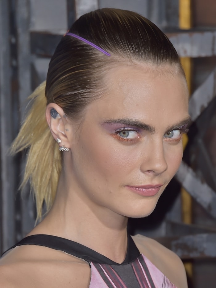 Graphic purple-and-orange eye makeup mirrored the color palette of Cara Delevingne's Iris van Herpen couture gown