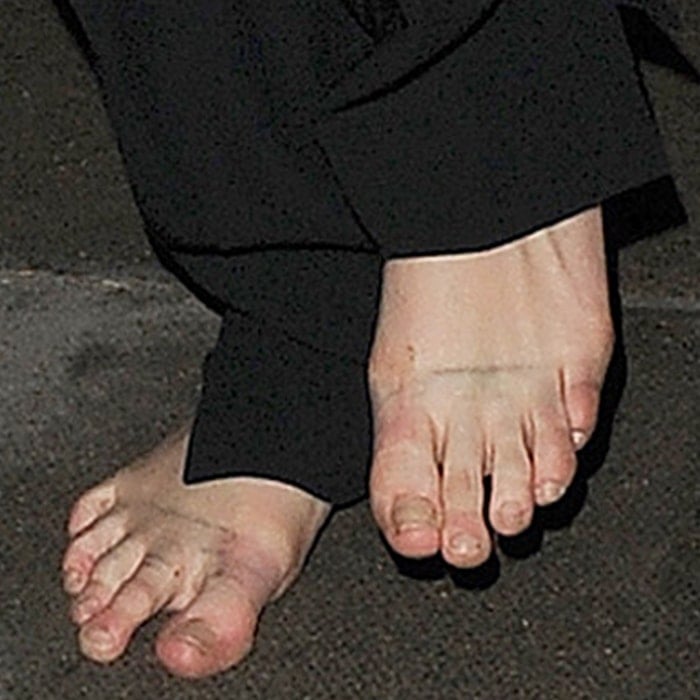 Cara Delevingne's long, slender toes, often referred to as "finger toes," are visible in this barefoot close-up