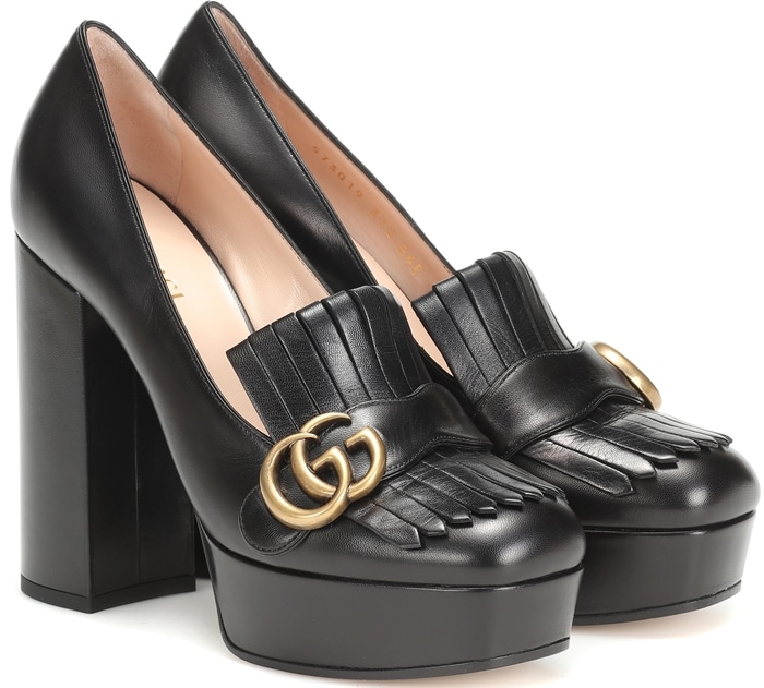 The platform pair has been crafted in Italy from black leather and is finished with chunky block heels