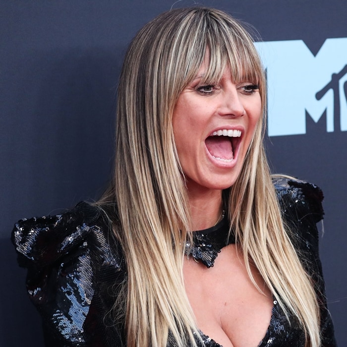 Heidi Klum delivers a high-energy red-carpet moment, her textured fringe and glossy sequins catching the light as she opens her mouth mid-cheer