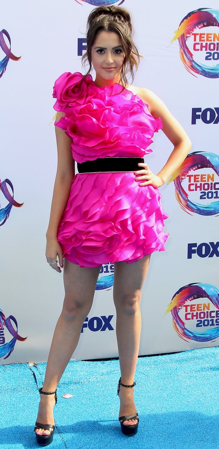 Laura Marano in a one-shoulder pink Raisa Vanessa mini dress and black Ruthie Davis Trophy Bling platform heels
