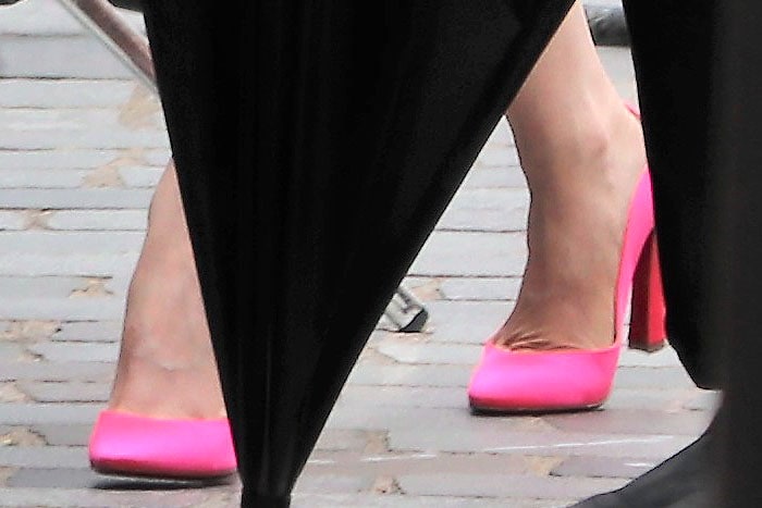 Lily Collins wearing vivid pink Christian Louboutin Agneska Wave pumps while filming Emily in Paris