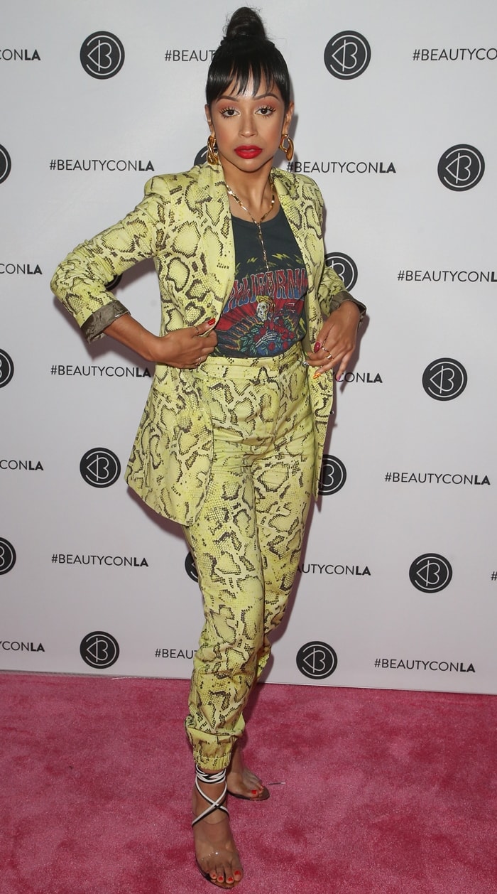 Liza Koshy sharpens her silhouette in a fitted Pinko suit, using slim-cut trousers and delicate ankle-wrap heels to elongate her petite frame