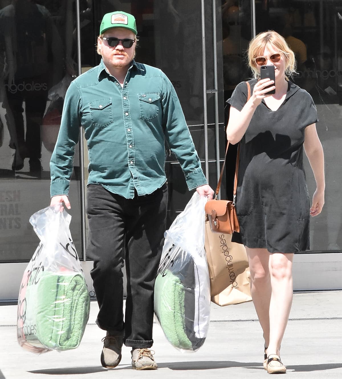 Stepping out in Los Angeles on April 4, 2018, a pregnant Kirsten Dunst embraced relaxed, off-duty elegance in a breezy black dress paired with Chanel raffia loafers, their woven texture adding a subtle spring-ready lift, while a Ralph Lauren Covered Lock Cartridge Bag brought structured, equestrian-inspired polish as she shopped at Bloomingdale’s with Jesse Plemons