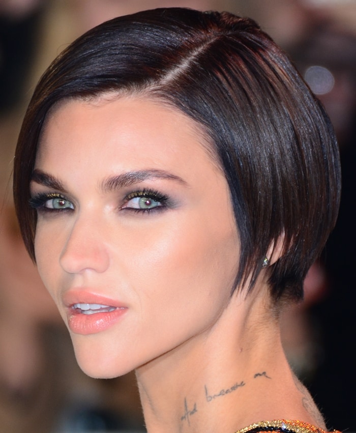Inscriptive 'And breathe me' neck tattoo on Ruby Rose, inspired by Sia's poignant song, captures a personal sentiment