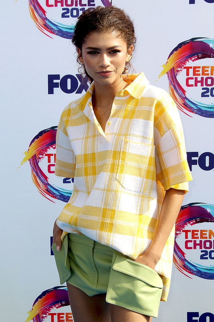 Zendaya's effortlessly chic look featured a casual curly updo paired with a vibrant yellow plaid shirt and avocado green shorts straight from the Jacquemus Spring 2020 runway